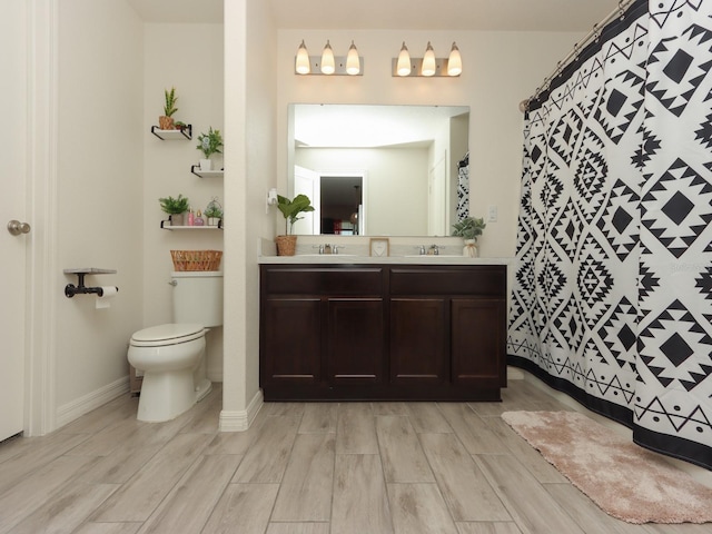 bathroom featuring vanity, toilet, and hardwood / wood-style flooring