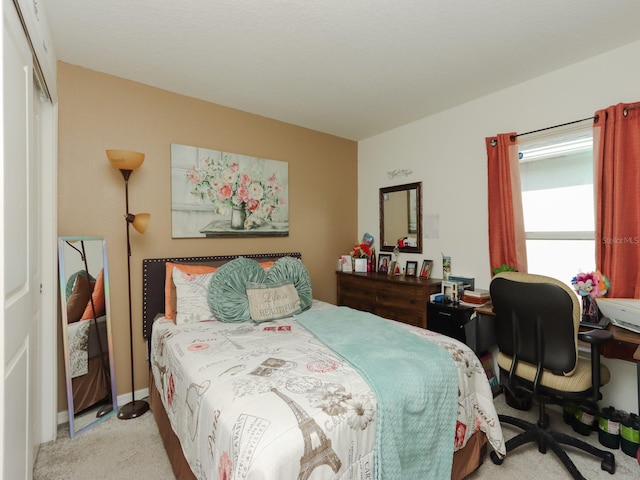 bedroom with light carpet and a closet