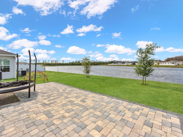 view of patio featuring a water view and central AC unit