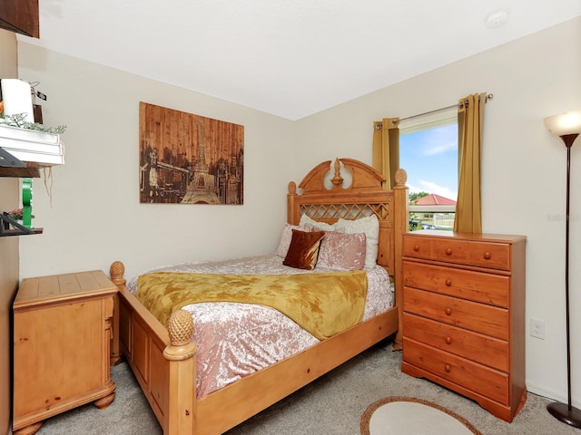 bedroom featuring light carpet