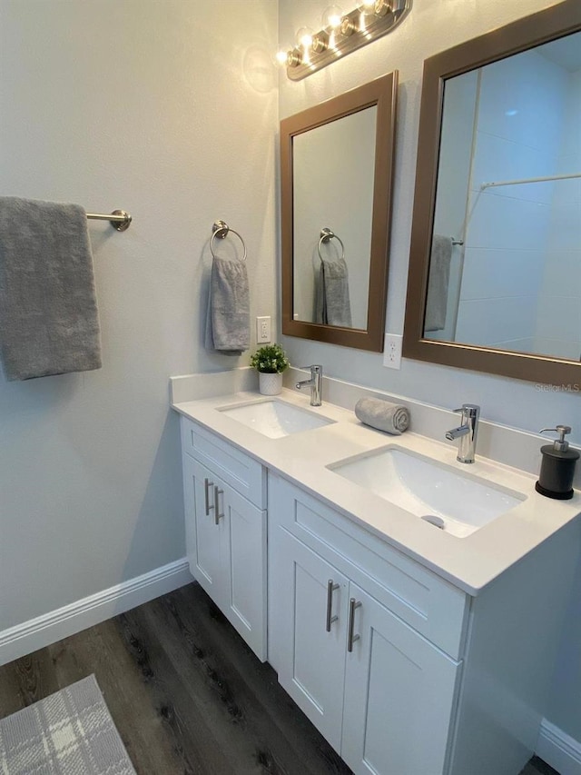 bathroom with hardwood / wood-style flooring and vanity