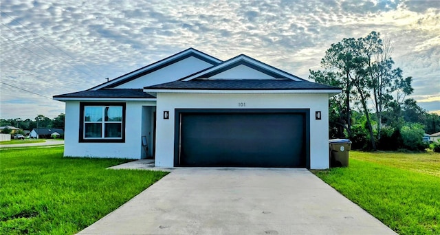 view of front of house with a garage and a front yard