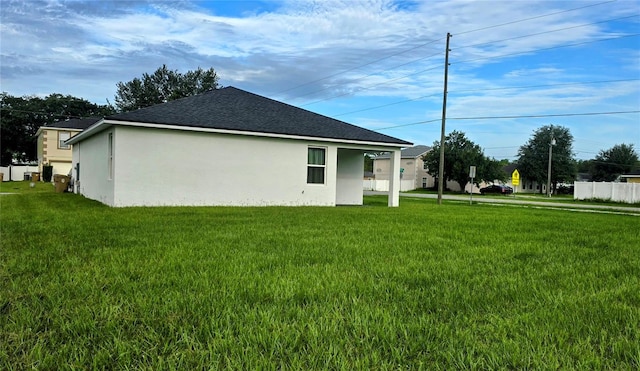 view of side of home featuring a yard