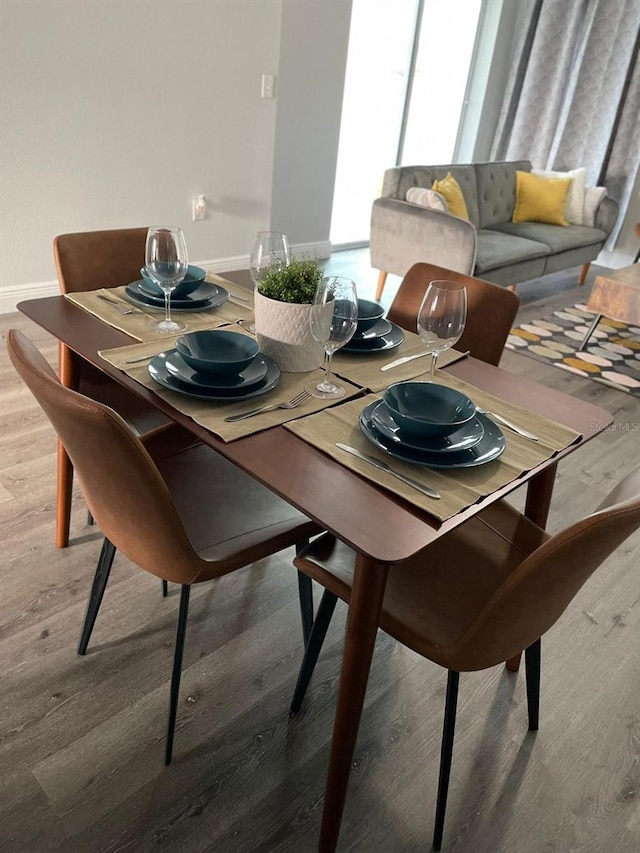 dining area with hardwood / wood-style floors