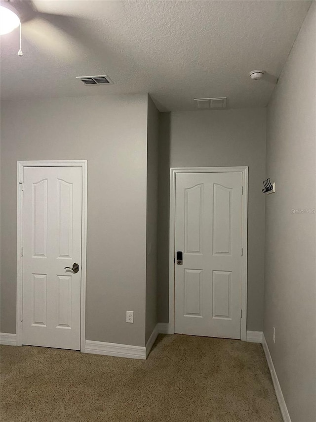 hallway featuring a textured ceiling