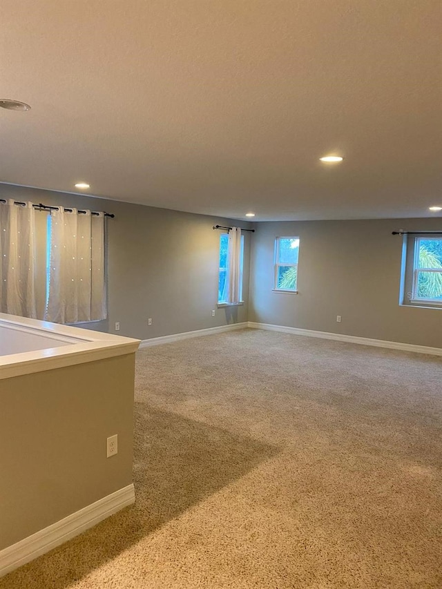 carpeted empty room featuring a healthy amount of sunlight