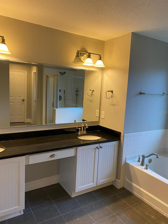 bathroom featuring vanity, separate shower and tub, and a textured ceiling