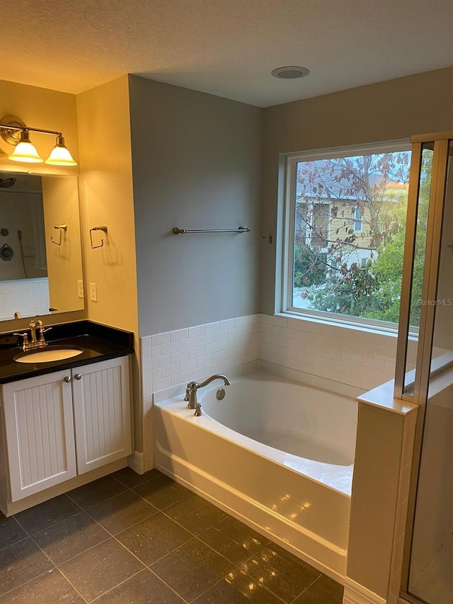 bathroom featuring vanity, a bathtub, and tile patterned floors