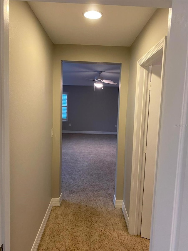 hallway with light colored carpet