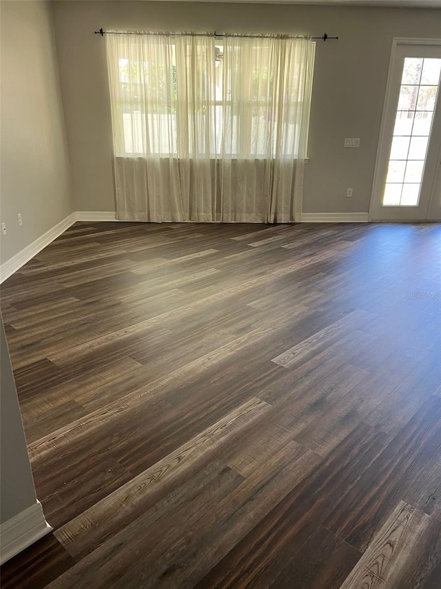 spare room with dark hardwood / wood-style floors