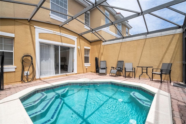 view of swimming pool featuring a lanai