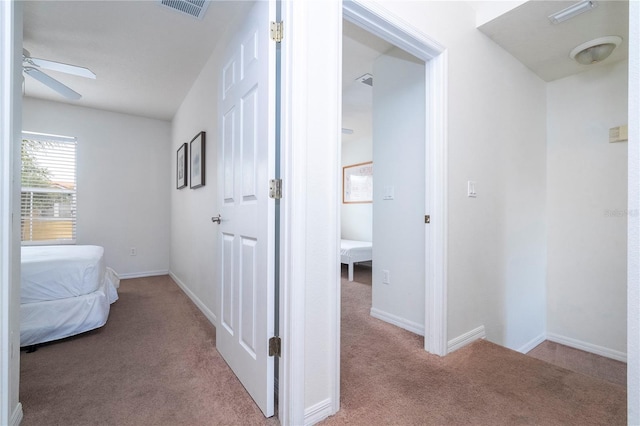 hallway with light colored carpet