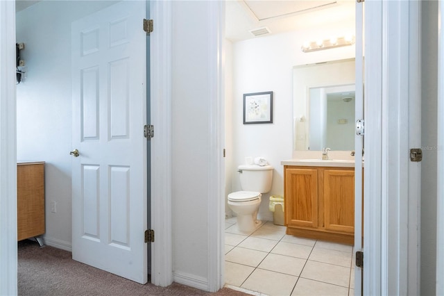 bathroom with vanity, tile patterned floors, and toilet