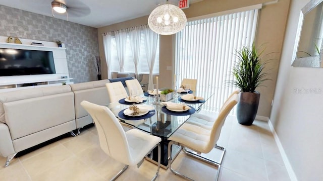 tiled dining space featuring ceiling fan