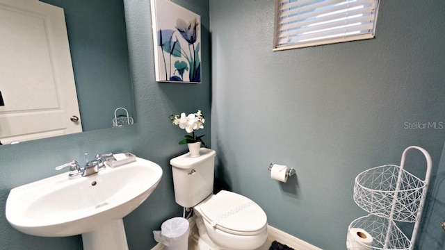 bathroom featuring sink and toilet