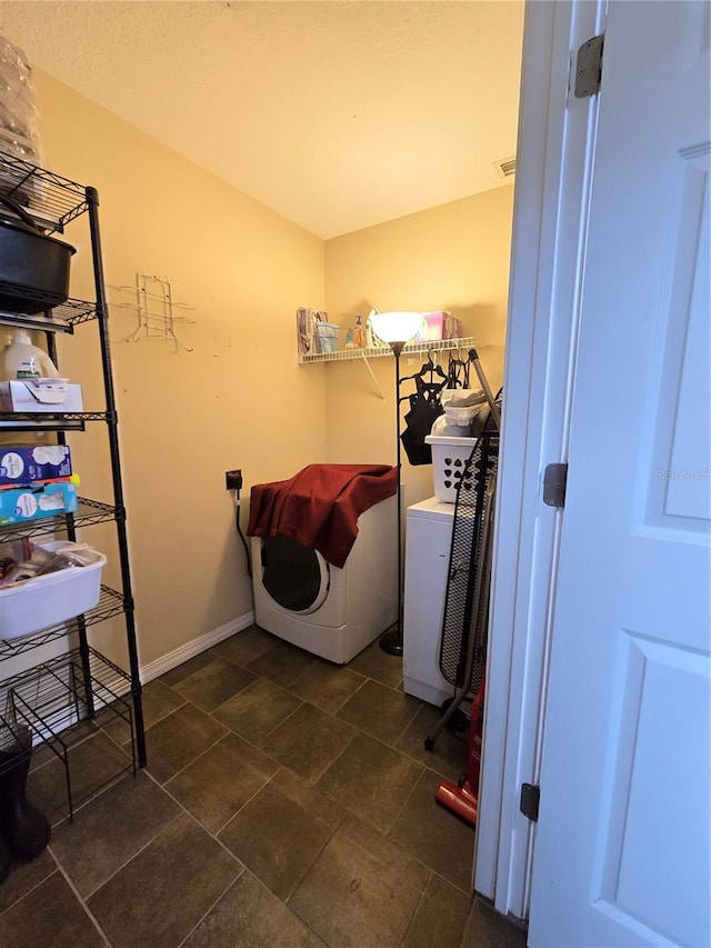 laundry room featuring dark tile patterned floors