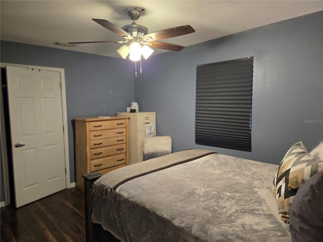 bedroom with dark hardwood / wood-style flooring and ceiling fan