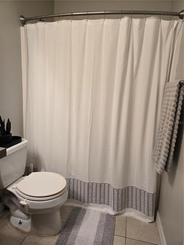 bathroom with tile patterned floors and toilet