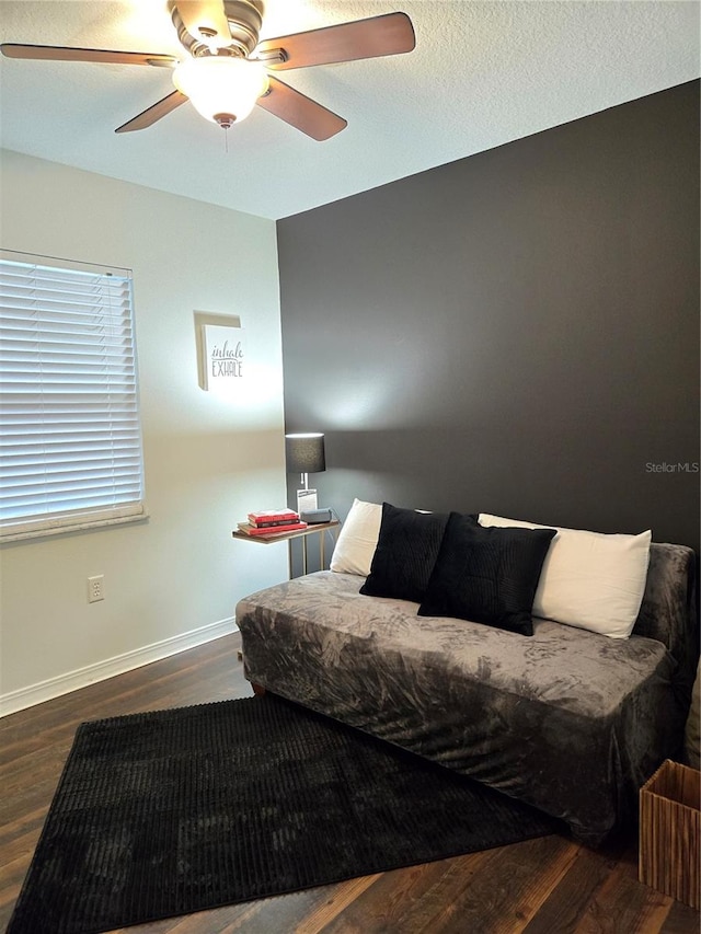 bedroom featuring ceiling fan and hardwood / wood-style flooring