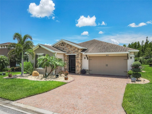 ranch-style home featuring a garage and a front lawn