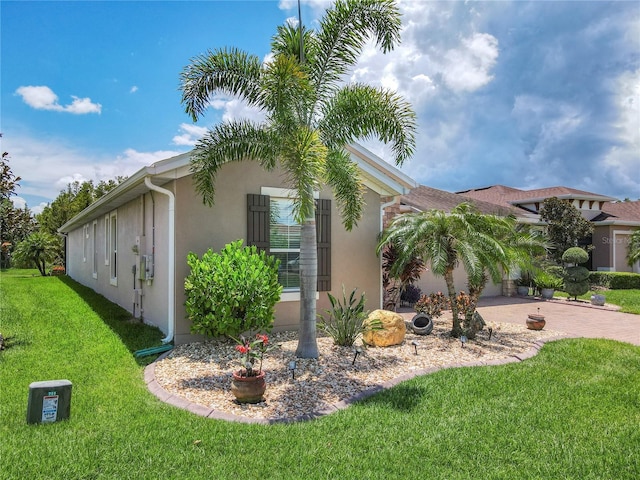 view of home's exterior featuring a patio area and a yard