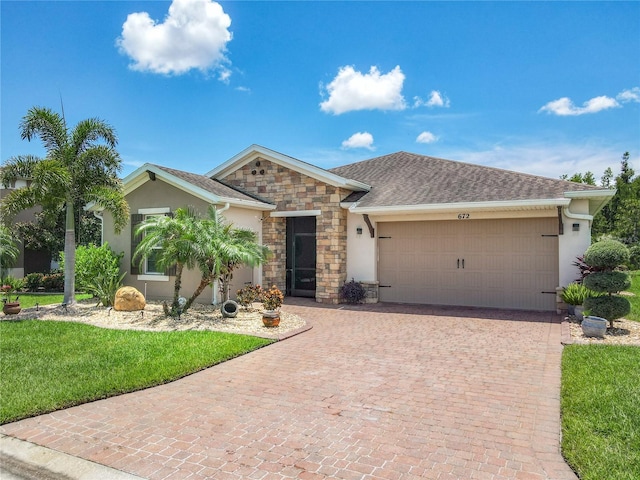 single story home featuring a garage and a front lawn