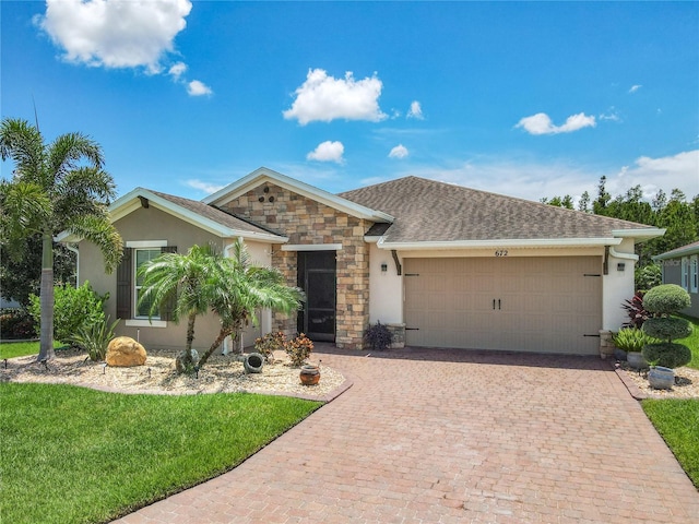 view of front facade with a garage and a front lawn