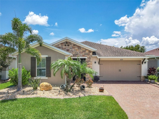 ranch-style home featuring a garage and a front lawn