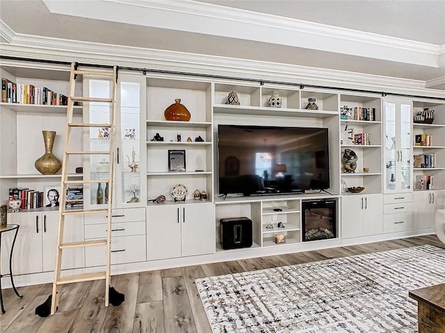 interior space with ornamental molding and hardwood / wood-style floors