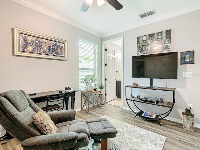 living room featuring ceiling fan, wood-type flooring, and ornamental molding