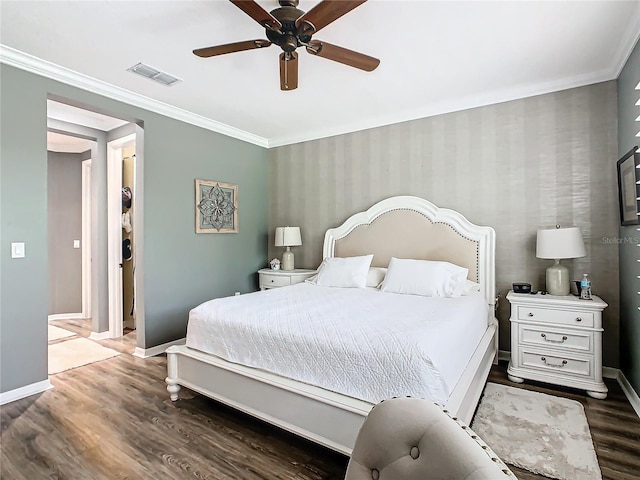 bedroom featuring dark wood-type flooring, ceiling fan, and ornamental molding