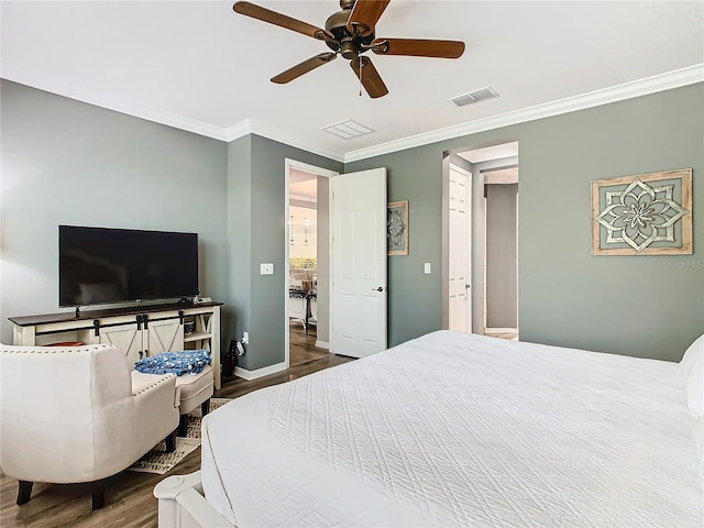 bedroom with ceiling fan, ornamental molding, and hardwood / wood-style flooring