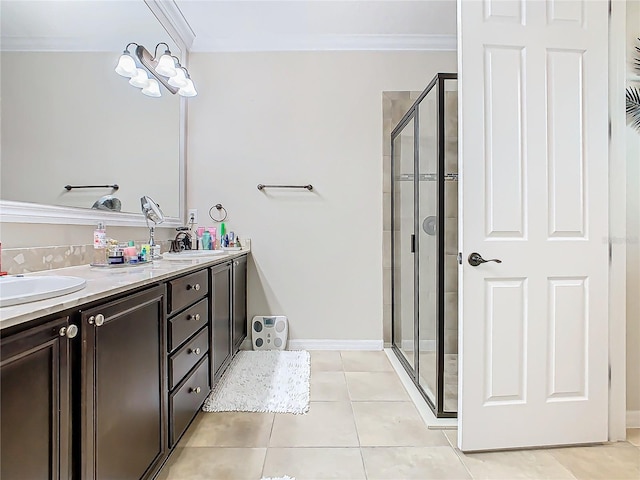 bathroom with crown molding, tile patterned flooring, a shower with shower door, and vanity