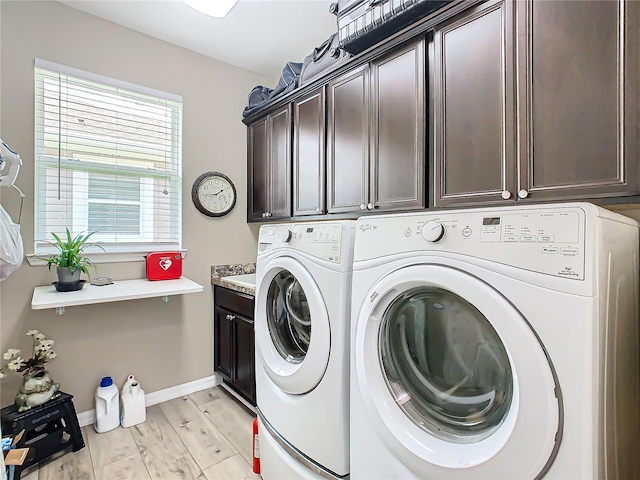 clothes washing area with light wood-type flooring, cabinets, and independent washer and dryer