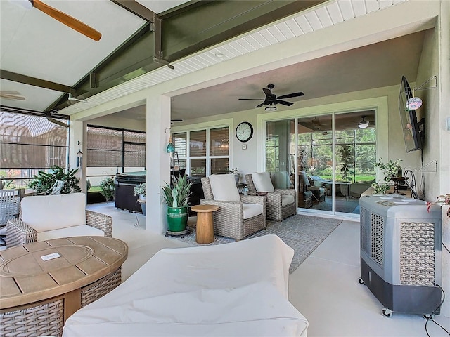 view of patio featuring ceiling fan, a hot tub, and an outdoor hangout area