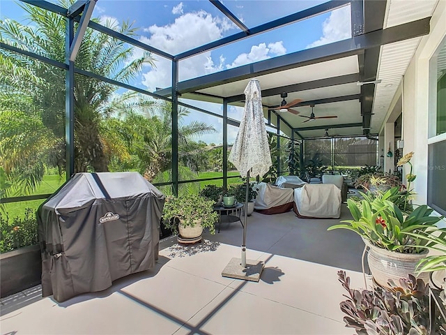 view of patio with ceiling fan, a lanai, and a grill