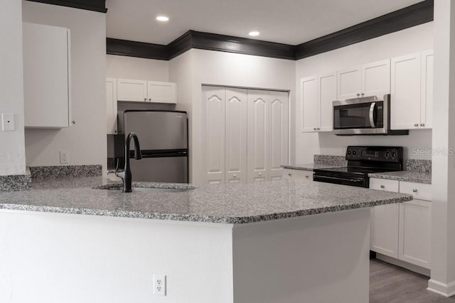 kitchen with white cabinetry, sink, light stone counters, crown molding, and appliances with stainless steel finishes