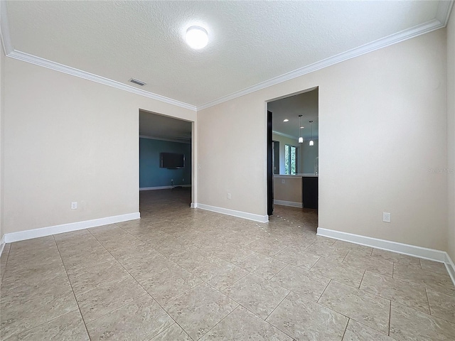 spare room featuring a textured ceiling and crown molding