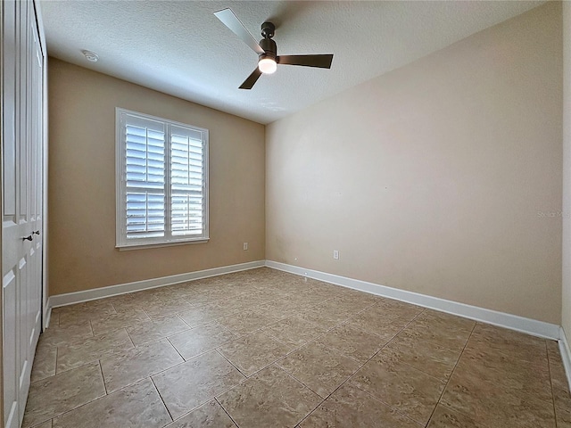 empty room featuring a textured ceiling and ceiling fan