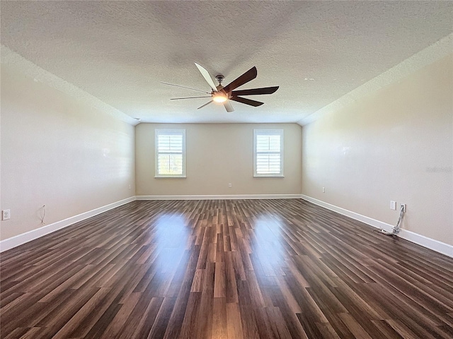 unfurnished room featuring dark wood-type flooring and a textured ceiling