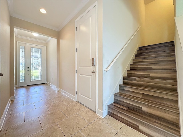 foyer featuring light tile patterned floors and crown molding