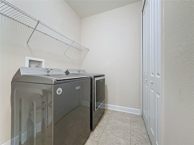 washroom with washing machine and clothes dryer