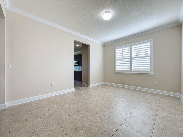 unfurnished room with a textured ceiling and ornamental molding