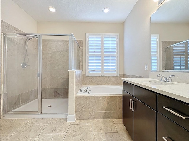 bathroom with tile patterned flooring, shower with separate bathtub, and vanity