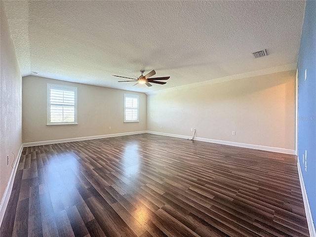 unfurnished room with a textured ceiling, ceiling fan, dark hardwood / wood-style flooring, and vaulted ceiling