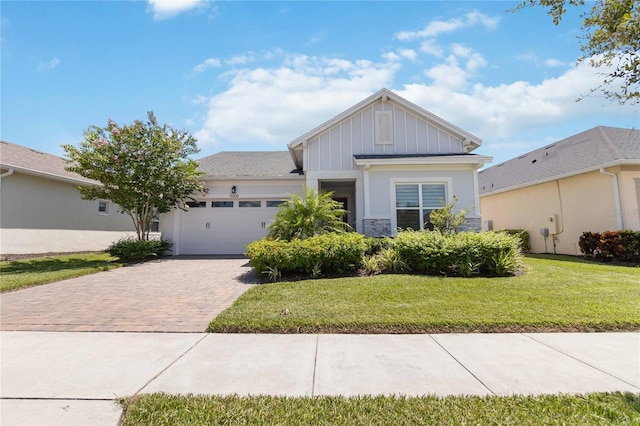 view of front of property with a garage and a front yard