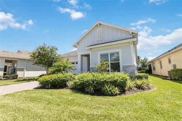 view of side of property with a garage and a lawn