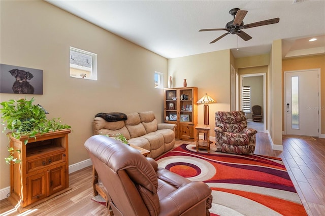 living room with ceiling fan and light hardwood / wood-style floors