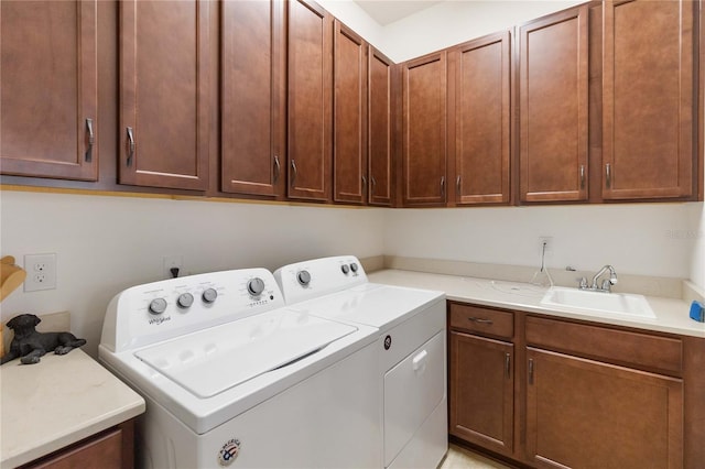 washroom featuring cabinets, separate washer and dryer, and sink