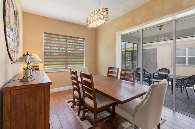 dining space featuring plenty of natural light and light hardwood / wood-style flooring